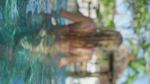 Blonde Sexy Girl in a Swimsuit Enters the Pool Sunny Weather Slow Mo Back View