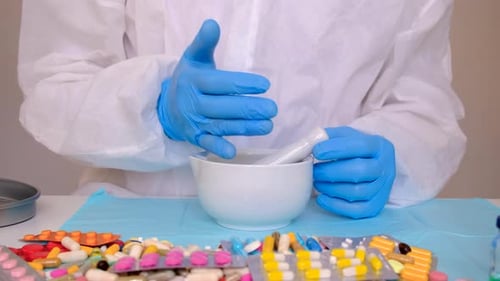 Scientist Grinding Pills in Mortar and Pestle