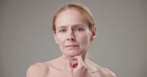Mature Woman Touching Her Face and Neck
