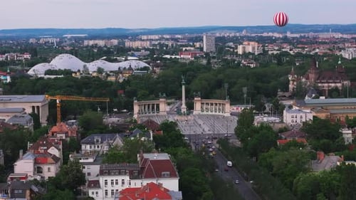 Aerial Slide and Pan Shot of Heroes Square with Iconic Millennium Monument Striped Balloon Flying