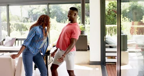 Happy Couple Dancing Together in a Bright Home