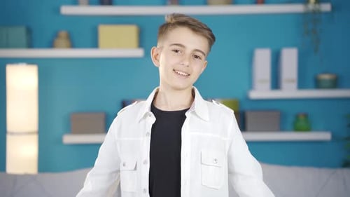 Smiling Boy Gives Thumbs Up Gesture Indoors
