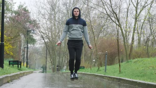 Man Jumps Rope in an Urban Park