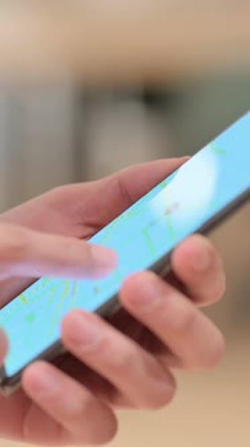 Hands Using a Smartphone for Online Map Navigation