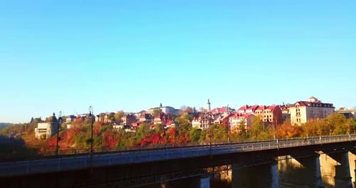 Picturesque Cityscape with Autumn Foliage and Bridge