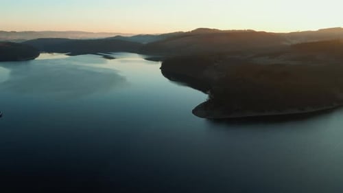 Aerial View of a Lake and Bridge at Golden Hour