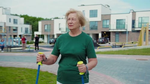 Active and Engaged Senior Walking with Fitness Bands in a Vibrant Modern Neighborhood