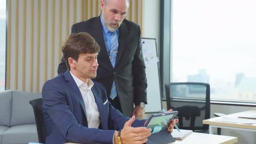 Caucasian professional businessman use tablet computer work in office.