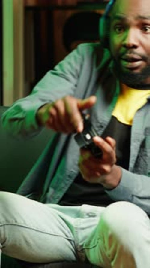 Young Adult Gamer Plays Video Game at Home