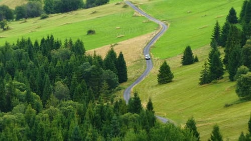 Scenic Drive Along a Winding Road Through Lush Green Countryside Landscapes