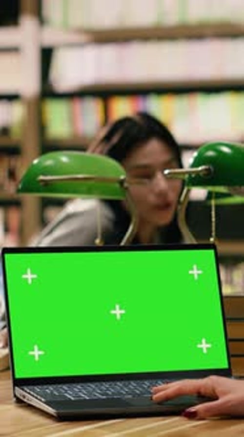 Vertical Video Green Screen Chroma Key on Laptop in Front of Study Group at Library Table