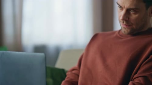 Tired Student Typing Laptop Studying Online in Home Close Up Man Worried Work