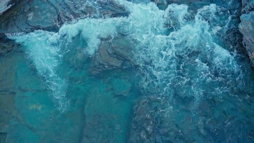 Overhead View Of River With Clear Water Flowing Through The Rocks. - aerial shot