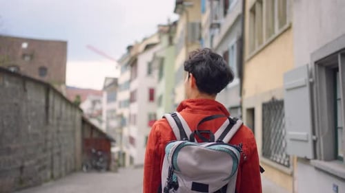 Asian attractive man backpacker walking around beautiful road in city.