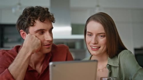 Family Couple Discussing Tablet Content Sitting Home Kitchen Together Closeup
