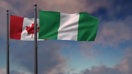 Realistic Waving Flags of Canada and Nigeria Against Sky