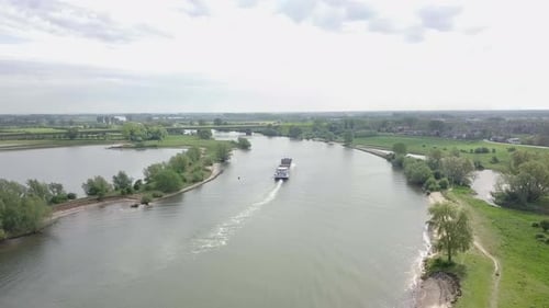 Aerial footage of the cargo ship on the river going away to the destination