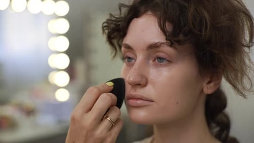 Woman Gets Makeup Done in Beauty Salon