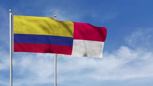 Colombia and Indonesia Flags Waving in Blue Sky