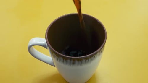 Fresh Coffee Being Poured Into Mug