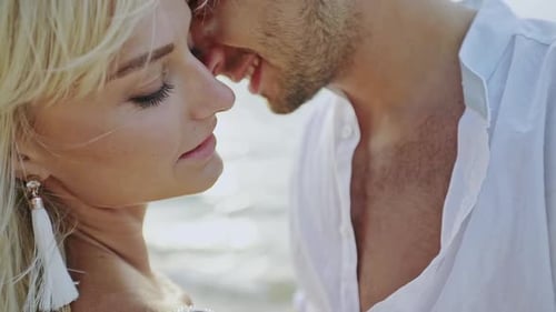 Loving Couple Embrace on a Beach at Sunset
