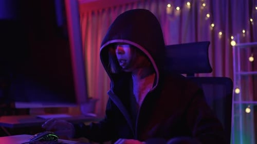 Young Adult Coding at Night in Dark Room