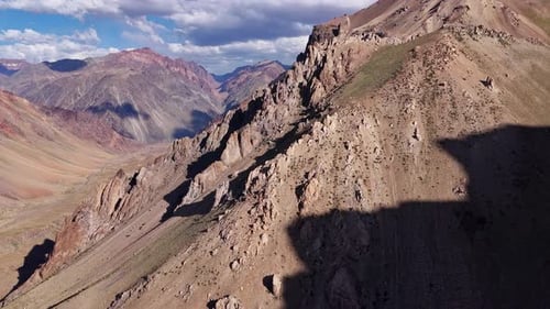 Breathtaking Aerial View of a Rugged Mountain Range Expansive Valley and Dramatic Shadows