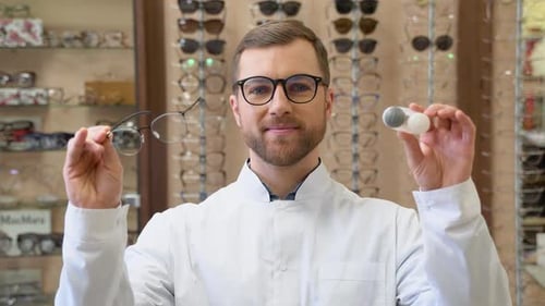 Ophthalmologist Hold Contact Lenses and Glasses in Hands Close Up