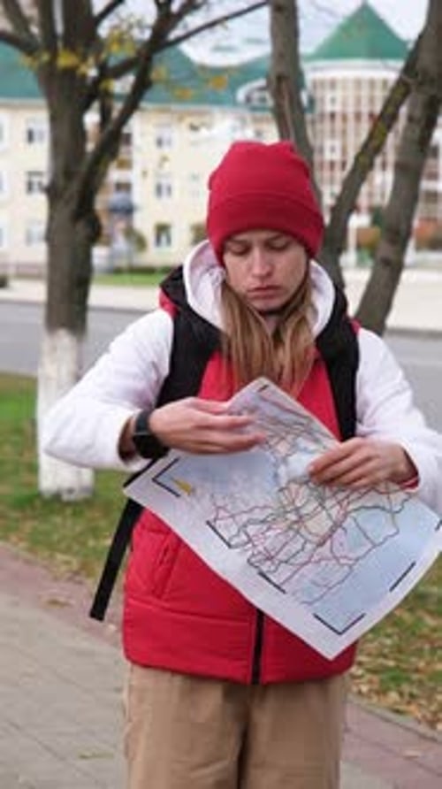 Woman Traveler Consulting a Map on City Sidewalk