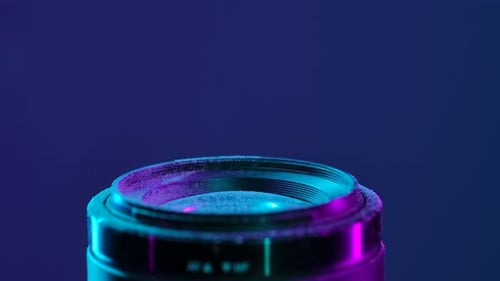 Cleaning Camera Lens with Brush Under Neon Light