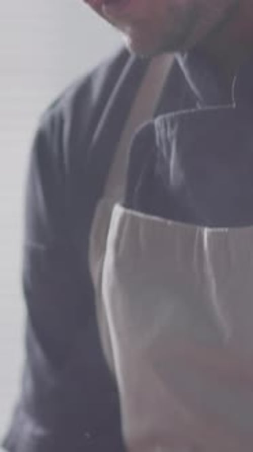 Close-up of Chef Adding Salt to Food Sizzling in Frying Pan