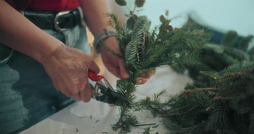 Woman Preparing Christmas Wreath Garland For Christmas Holidays