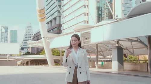 Young beautiful business woman holding coffee cup ready to work in modern city