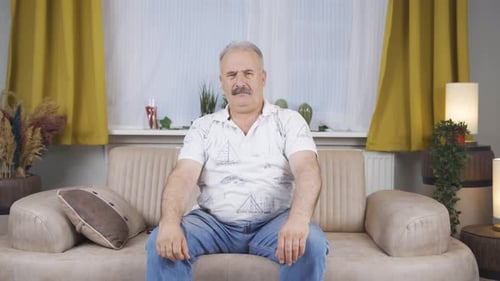 Old man looking negative at camera.