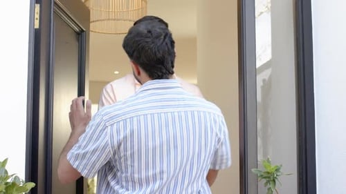 Man Welcomes Friends with Hugs into Modern House