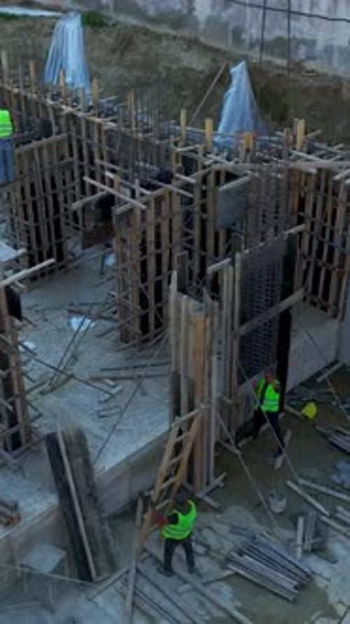 Vertical Video Construction Progress Captures Engineers Leading Skilled Teams on Rebar and Concrete