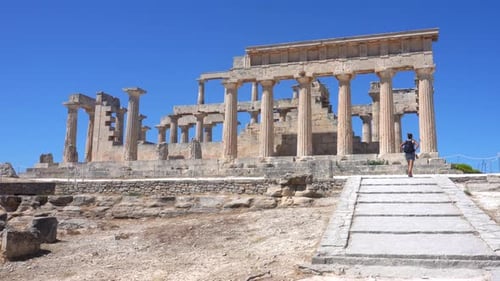 Tourist Walking Towards Ancient Temple of Aphaia in Greece