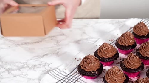 Packaging Chocolate Cupcakes with Chocolate Ganache Frosting Into a Paper Cupcake Box