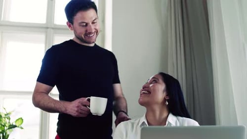 Smiling couple working together at a laptop