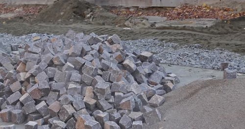 The Excavator Bucket is Used for Pouring Out Rocks Stones for Laying the Pavement of the Road