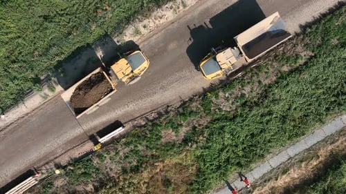 Dump Trucks Driving on Dirt Road, Aerial View