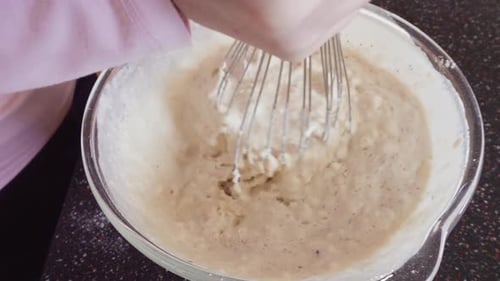 Mixing Ingredients in a Glass Mixing Bowl to Make Homemade Pancakes