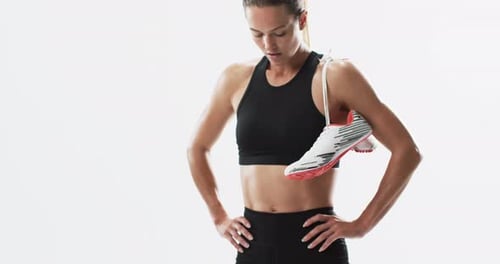 Athletic Woman Poses With Running Shoes