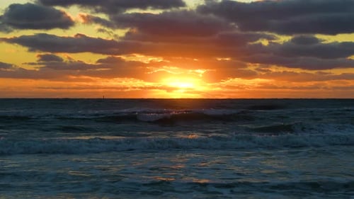 Ocean Sunset Landscape with Soft Evening Sea Water Waves Crushing on Sandy Beach
