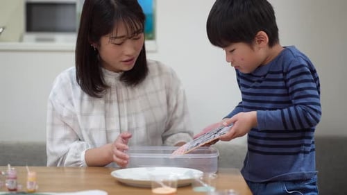 Woman and Child Creating Art Together Indoors