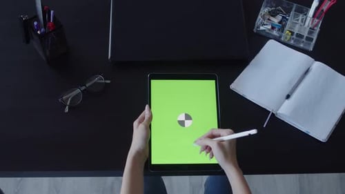 Woman's Hands Draw with Stylus on Digital Tablet on Table with Laptop Notebook and Other Office