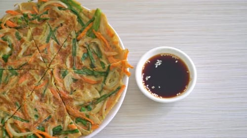 Overhead Shot of Savory Pancake Dish with Sauce