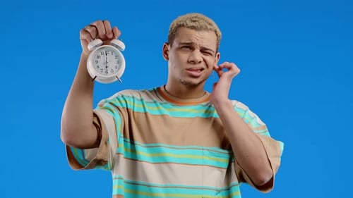 Woken Up By Alarm Clock Sleepy Man Holding It in Hand