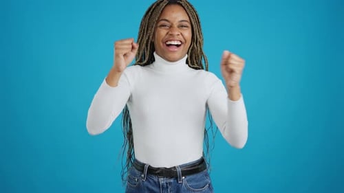African Woman Celebrating with Fists in the Air