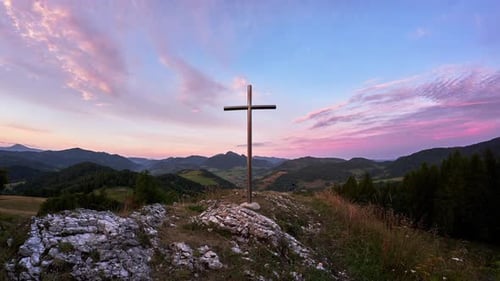 Christian Cross on a Rock in a Mountain Landscape Dramatic Clouds Over the Mountains